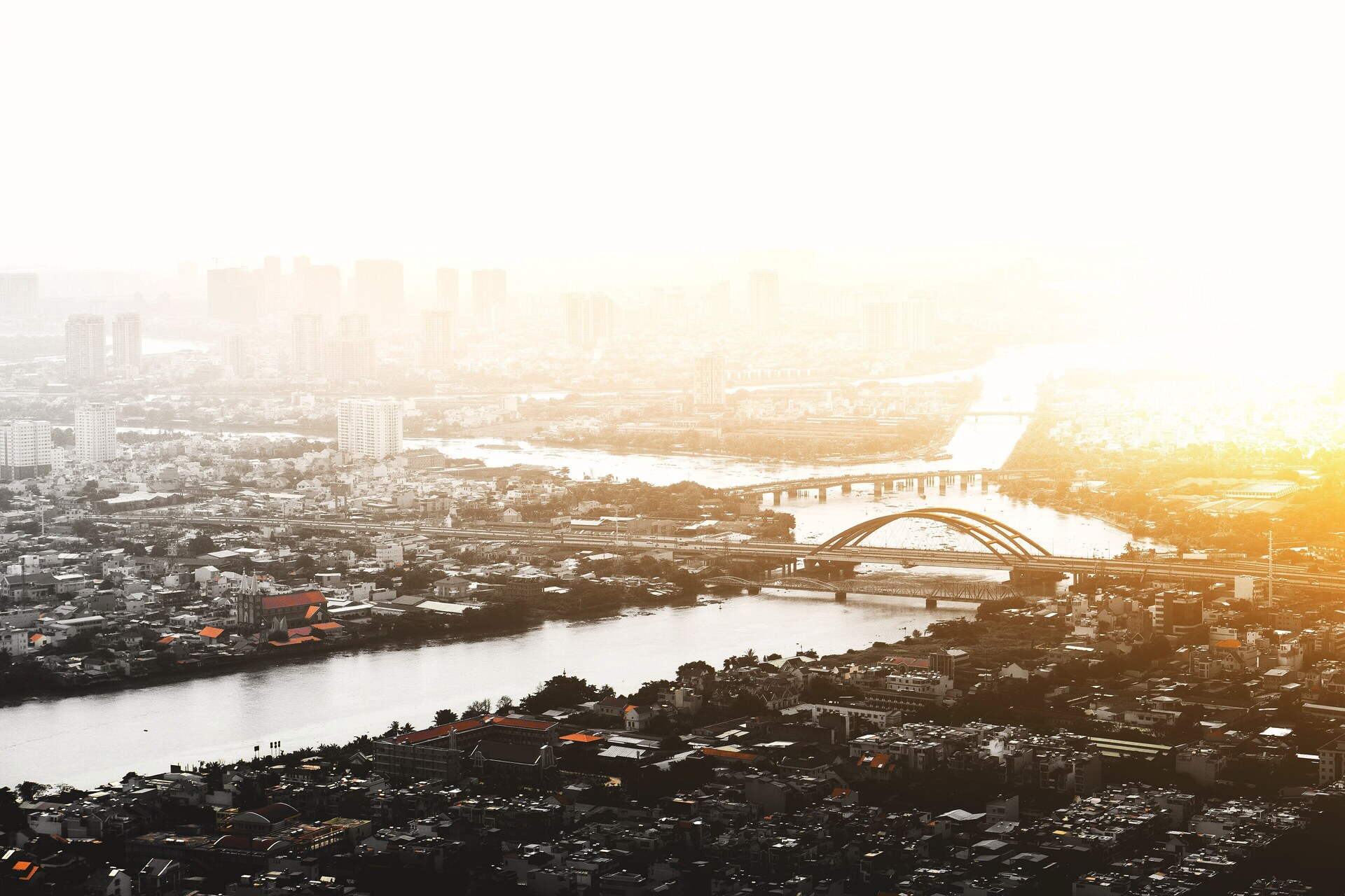 The Saigon river through Ho Chi Minh City at first light, with the city on both banks.